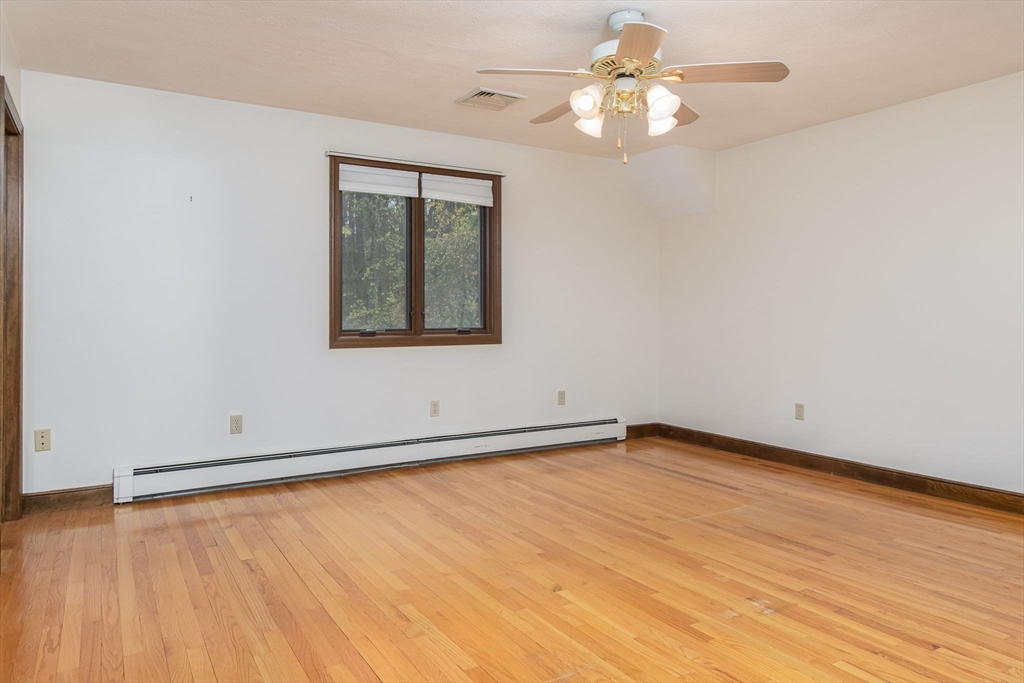 21 Saddle Lane Groton, MA 01450 - Photo 18 of 31 wooden floor in an empty room with a window