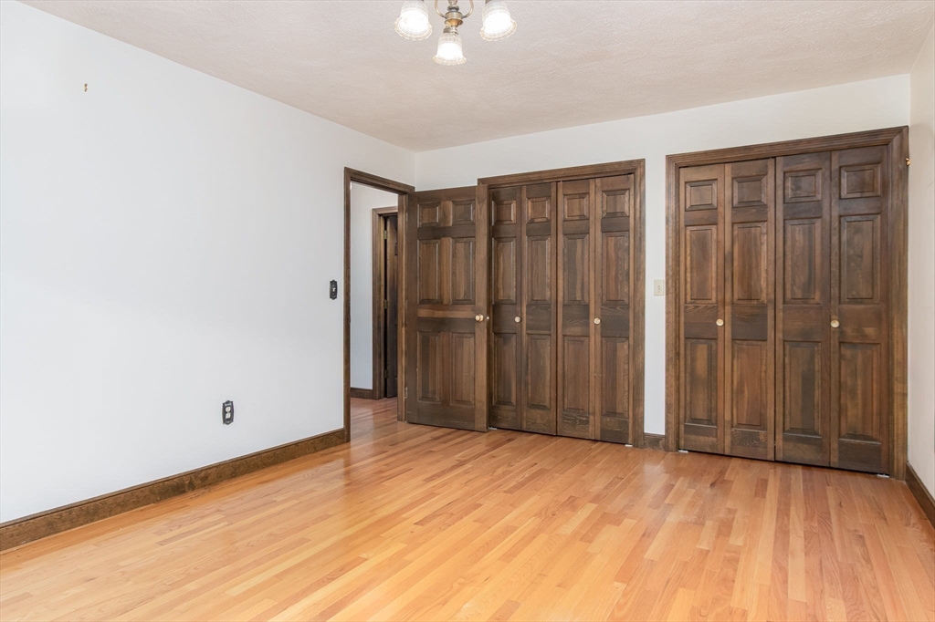 21 Saddle Lane Groton, MA 01450 - Photo 19 of 31 a view of empty room with wooden floor