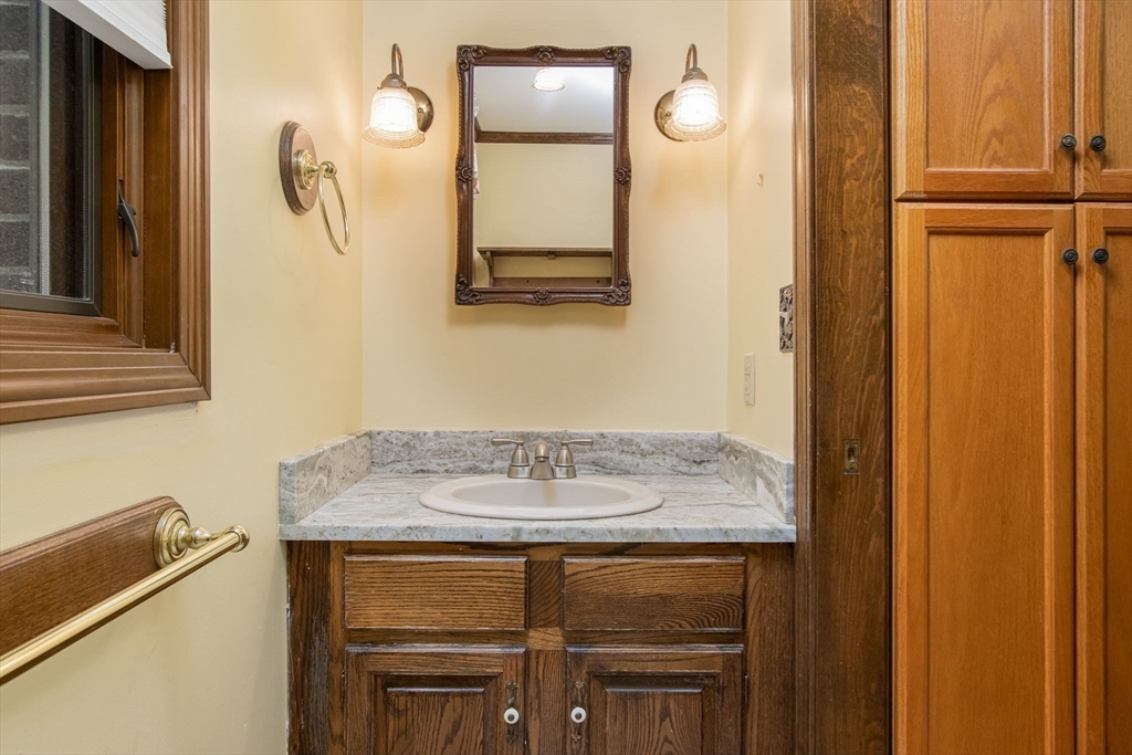 21 Saddle Lane Groton, MA 01450 - Photo 21 of 31 a bathroom with a granite countertop sink and a mirror