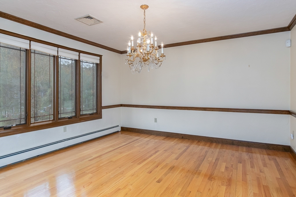 21 Saddle Lane Groton, MA 01450 - Photo 6 of 31 a view of wooden floor and chandelier