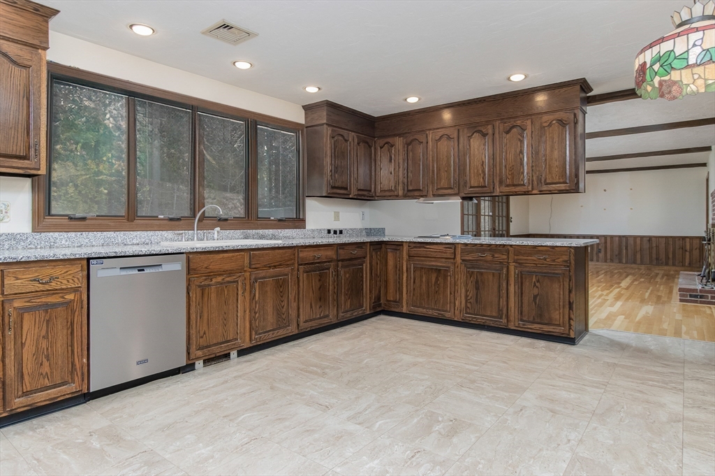 21 Saddle Lane Groton, MA 01450 - Photo 7 of 31 a kitchen with stainless steel appliances granite countertop a sink a stove and a refrigerator