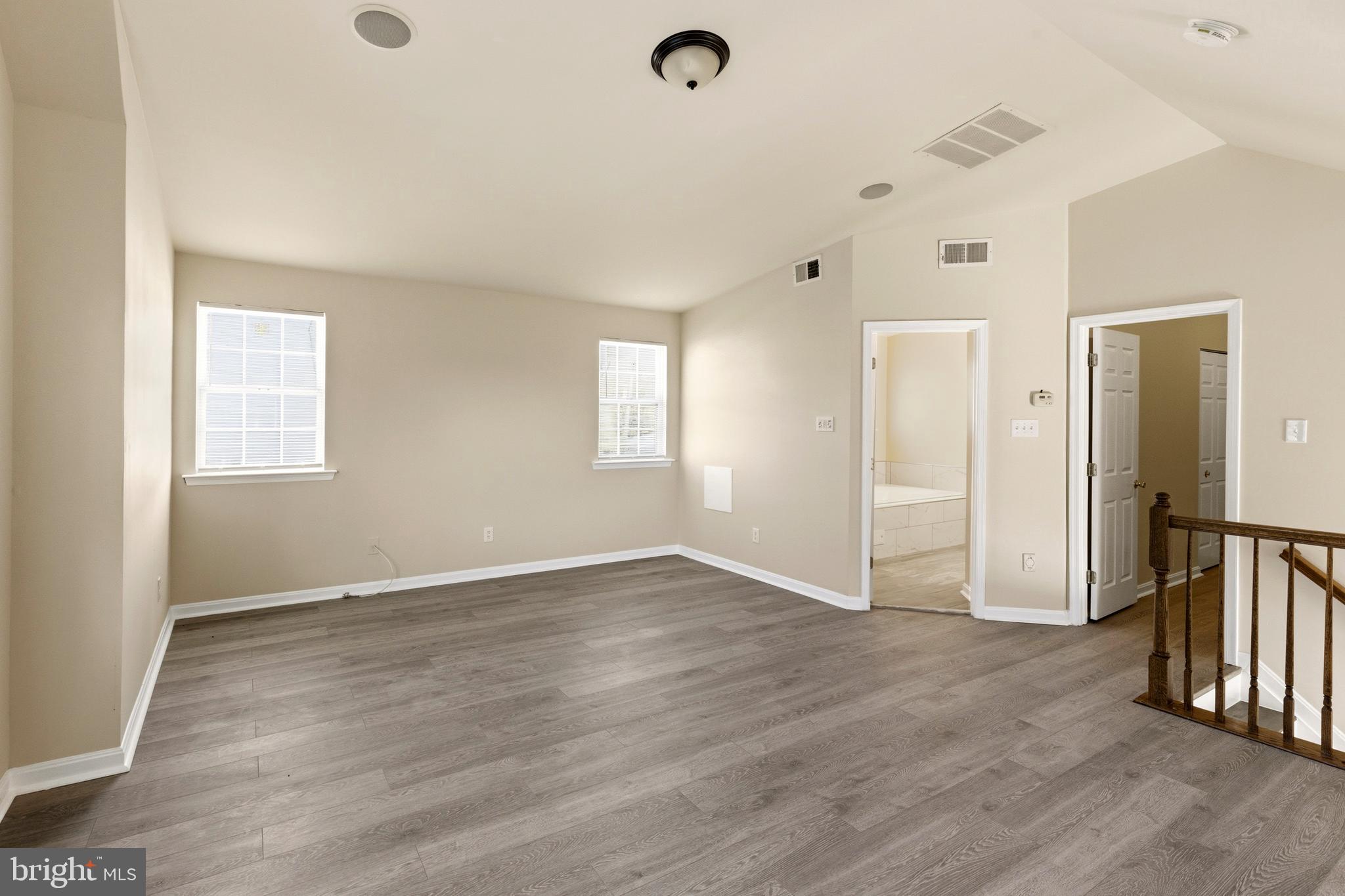 4704 Denview Way Baltimore, MD 21206 - Photo 24 of 42 an empty room with wooden floor and windows