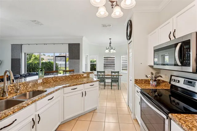 a kitchen with stainless steel appliances a sink stove and cabinets