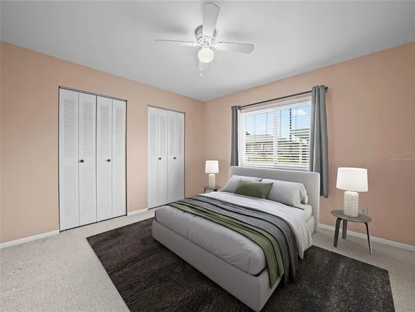 a bedroom with a large bed chandelier and a window