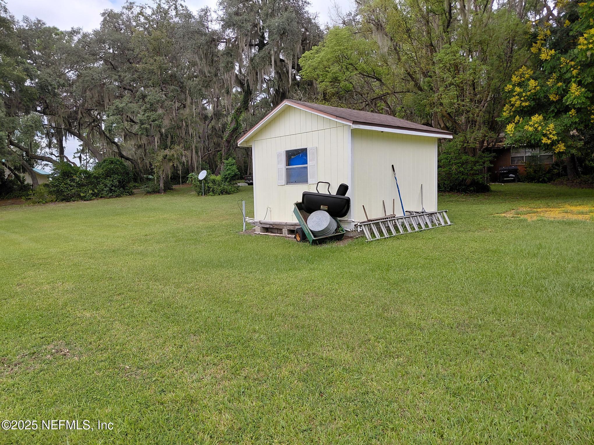 113 Lake Como Point Road Pomona Park, FL 32181 - Photo 13 of 36 a view of a house with a yard and sitting area