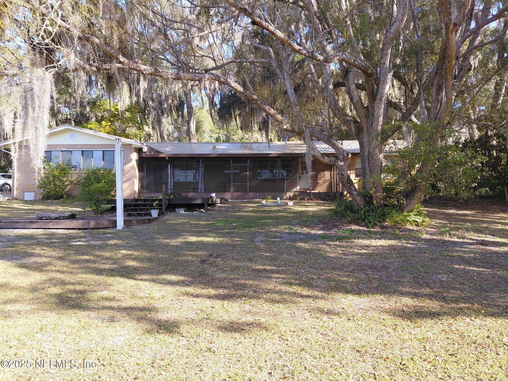 113 Lake Como Point Road Pomona Park, FL 32181 - Photo 17 of 36 a view of a house with a yard and tree s