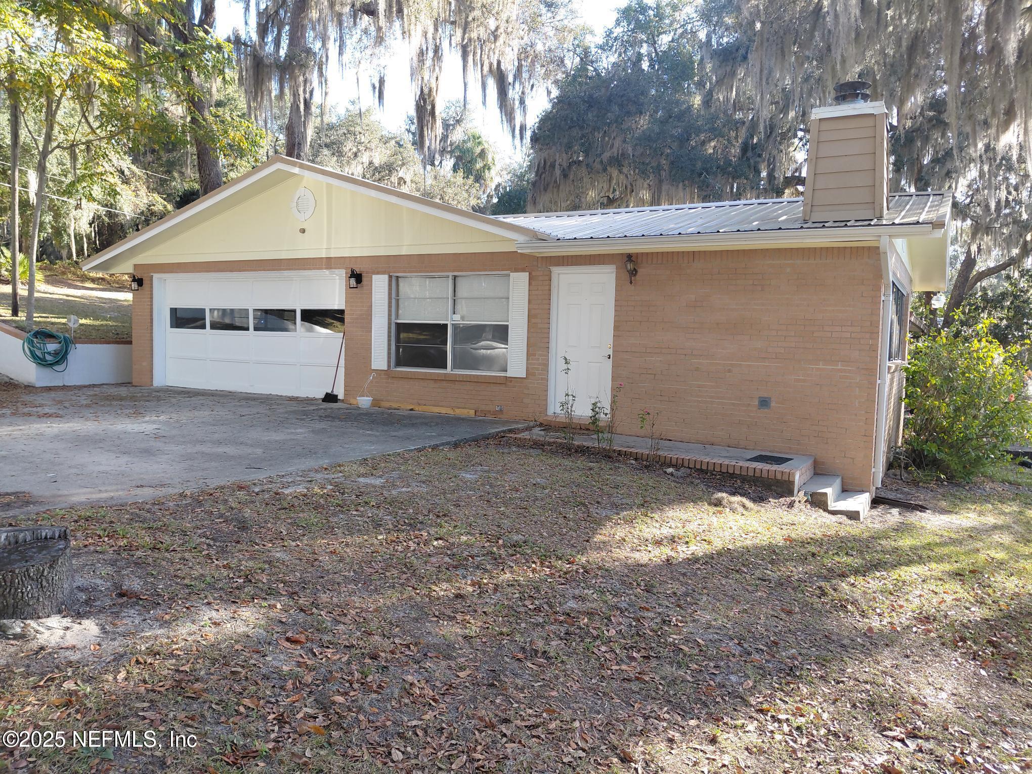 113 Lake Como Point Road Pomona Park, FL 32181 - Photo 18 of 36 a view of house with a yard and garage