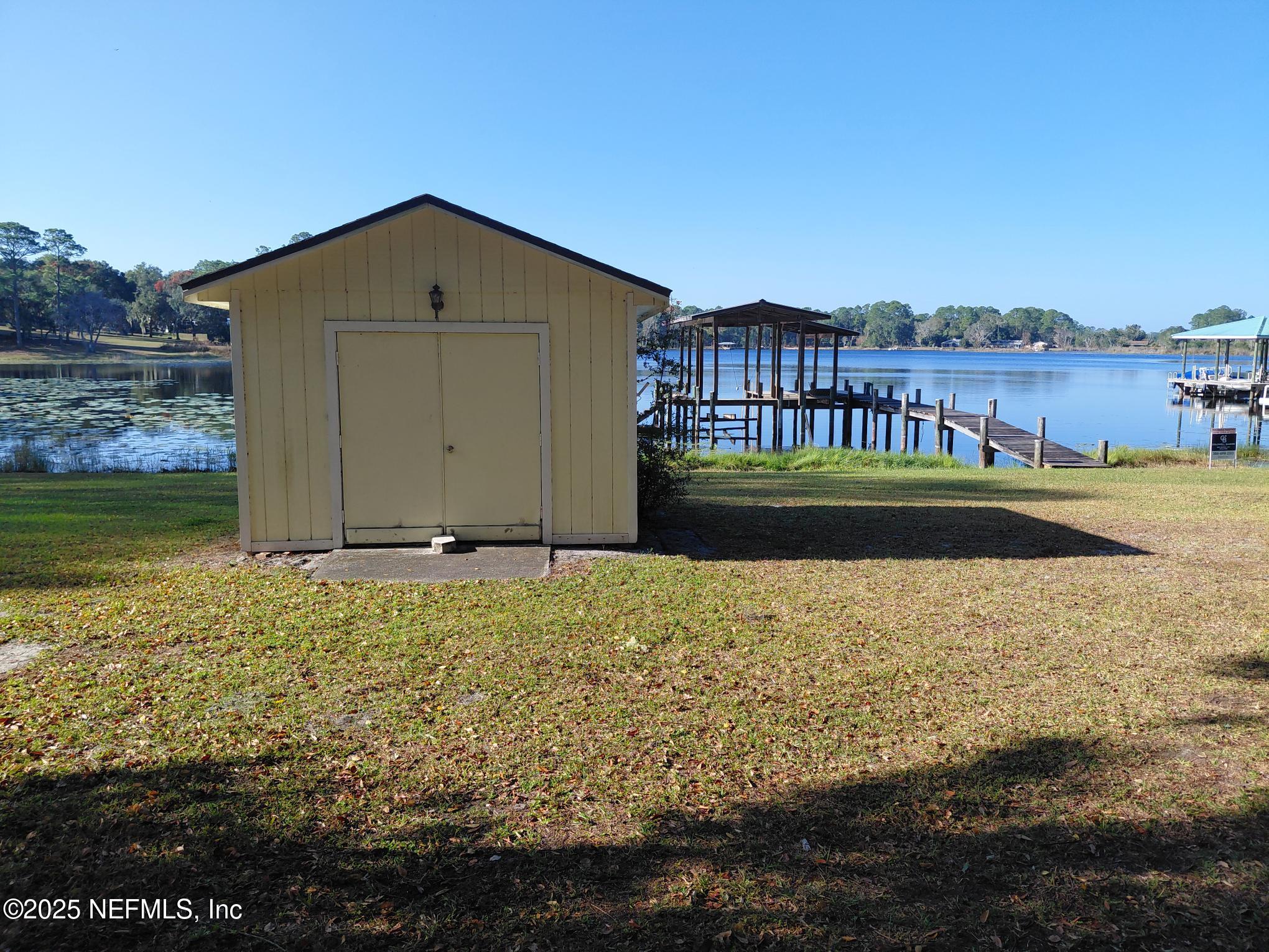 113 Lake Como Point Road Pomona Park, FL 32181 - Photo 19 of 36 a front view of a house with a yard