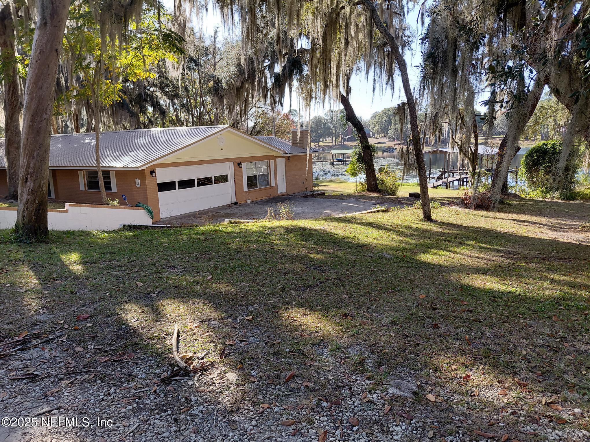 113 Lake Como Point Road Pomona Park, FL 32181 - Photo 3 of 36 a view of a house with a yard and tree s