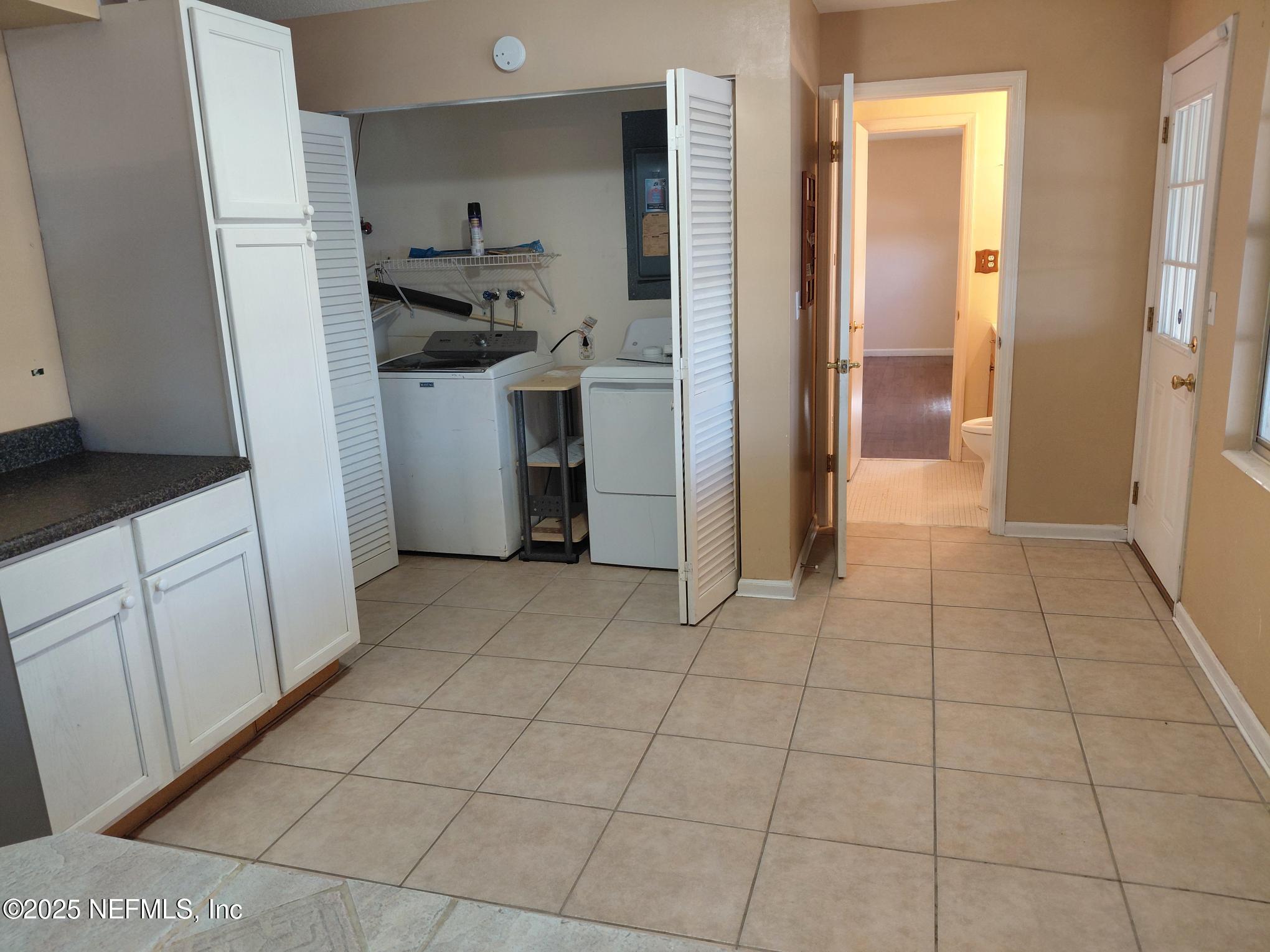 113 Lake Como Point Road Pomona Park, FL 32181 - Photo 34 of 36 a view of a kitchen with refrigerator and white cabinets