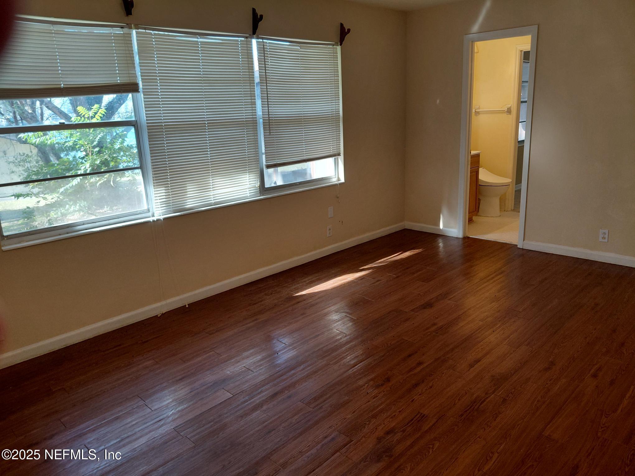 113 Lake Como Point Road Pomona Park, FL 32181 - Photo 35 of 36 an empty room with wooden floor and windows