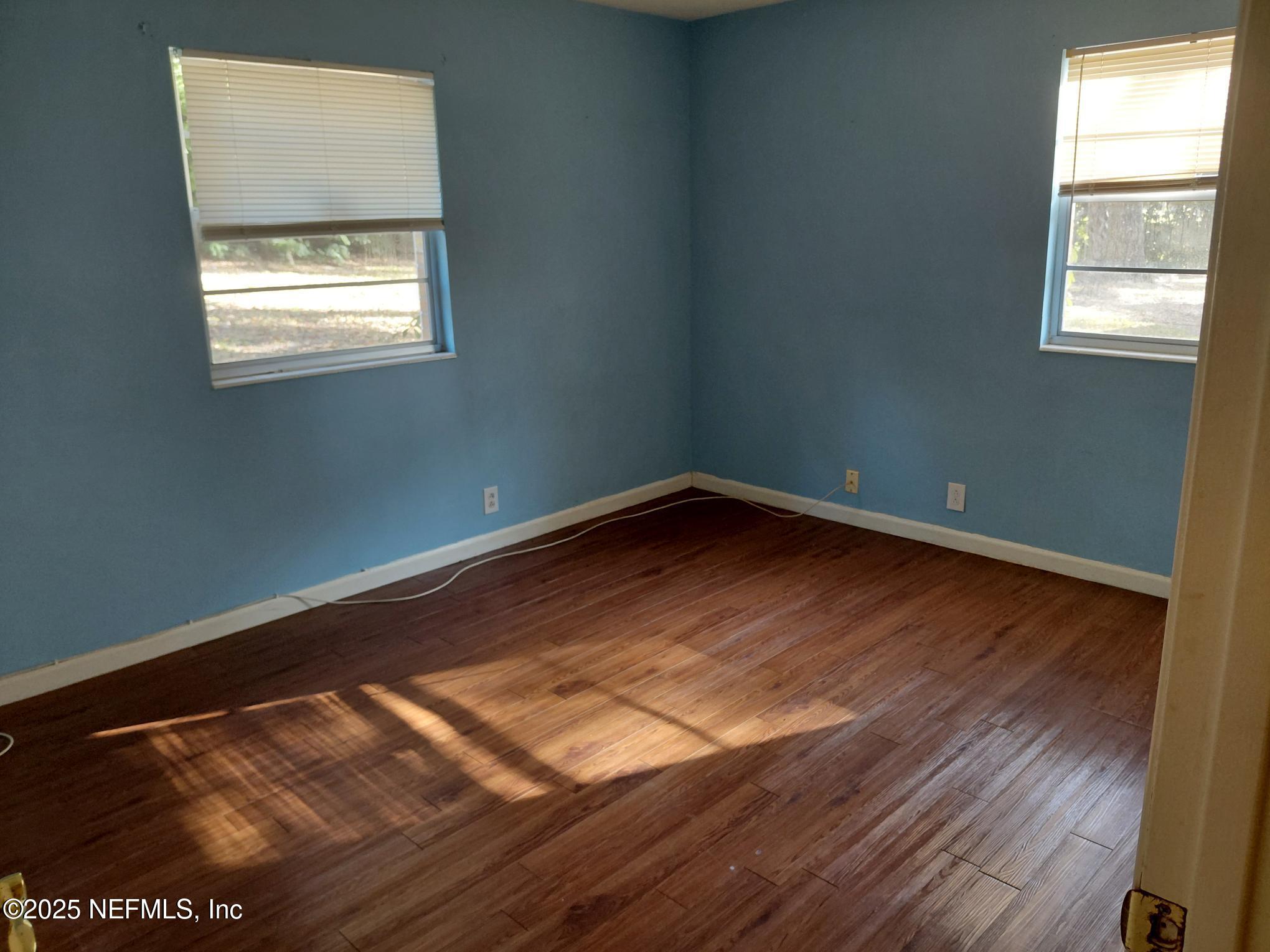 113 Lake Como Point Road Pomona Park, FL 32181 - Photo 36 of 36 an empty room with wooden floor and windows