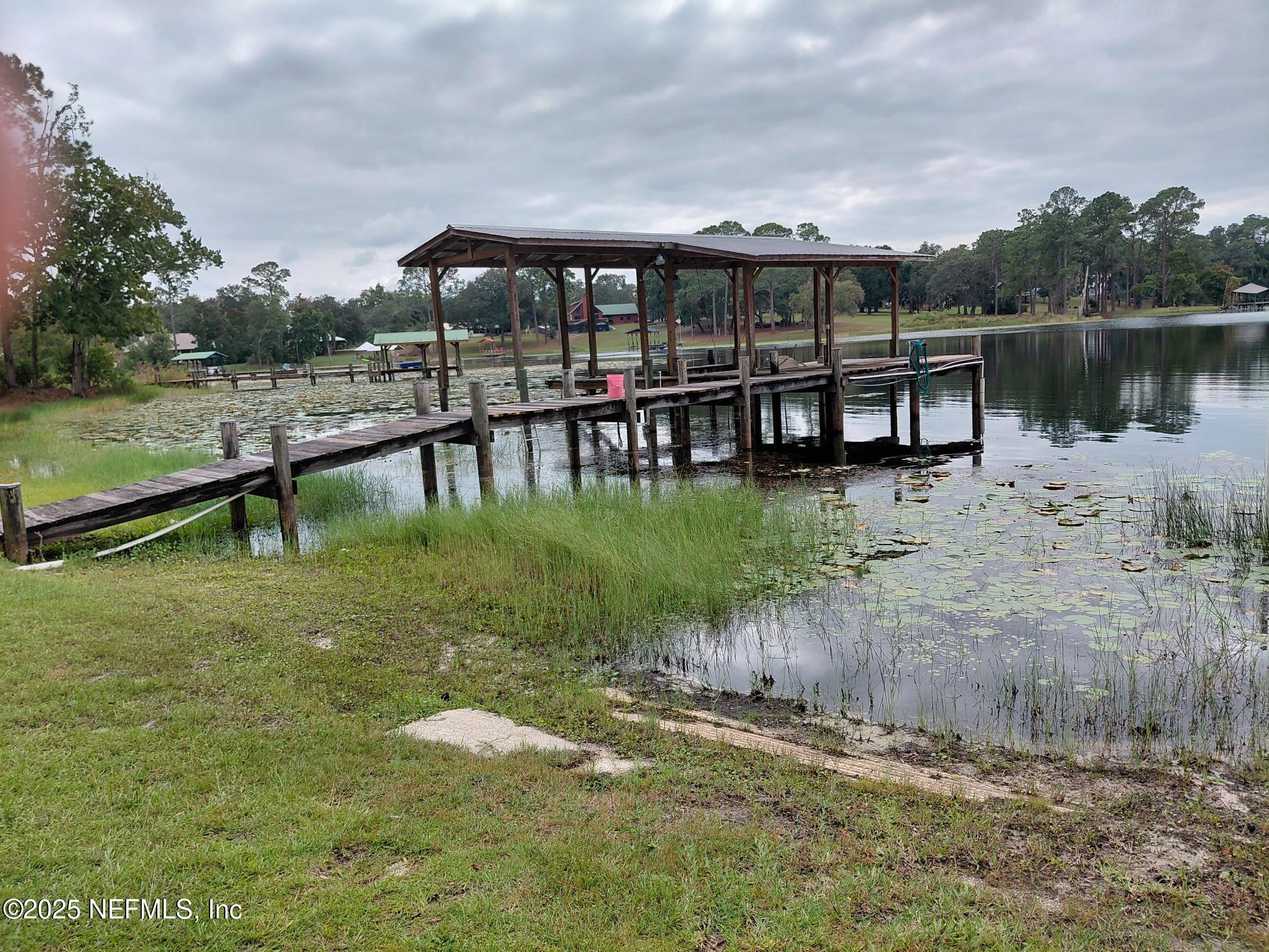 113 Lake Como Point Road Pomona Park, FL 32181 - Photo 7 of 36 a view of a lake with a yard