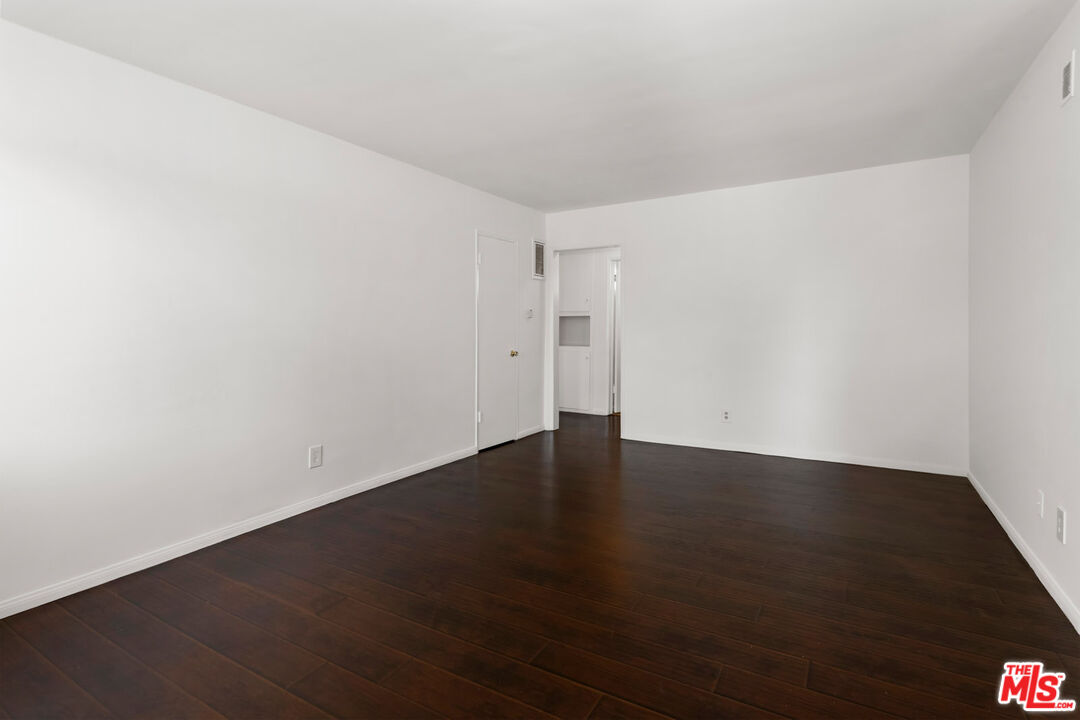 3355 South Canfield Avenue, Unit 11 Los Angeles, CA 90034 - Photo 2 of 23 an empty room with wooden floor