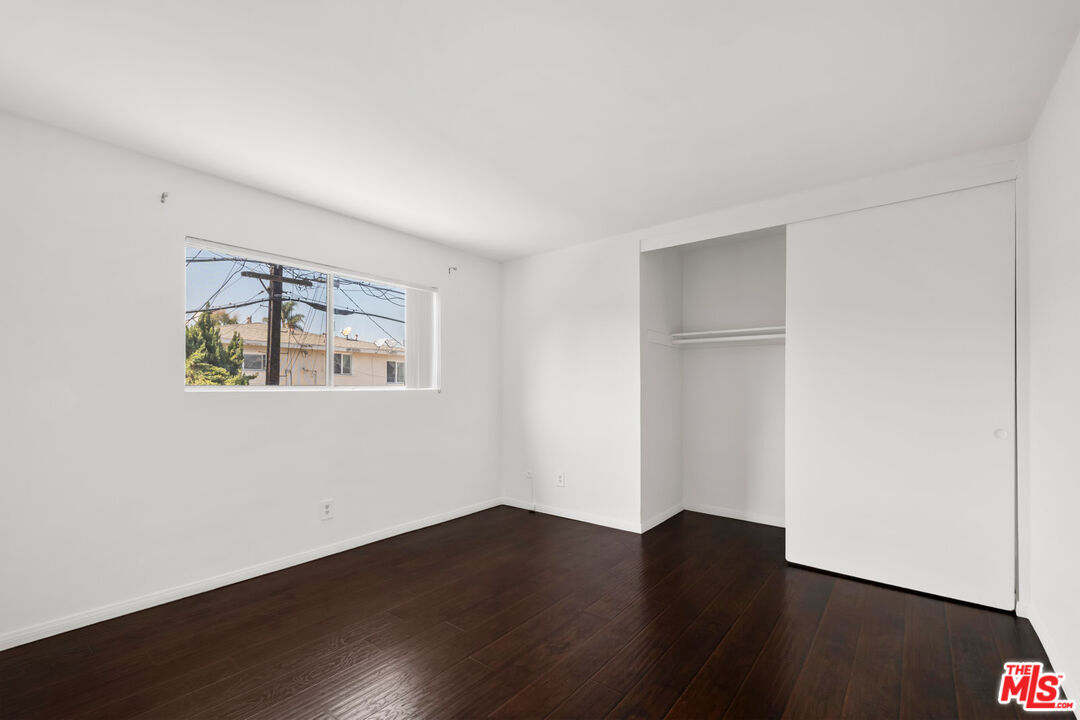 3355 South Canfield Avenue, Unit 11 Los Angeles, CA 90034 - Photo 10 of 23 a view of an empty room with wooden floor