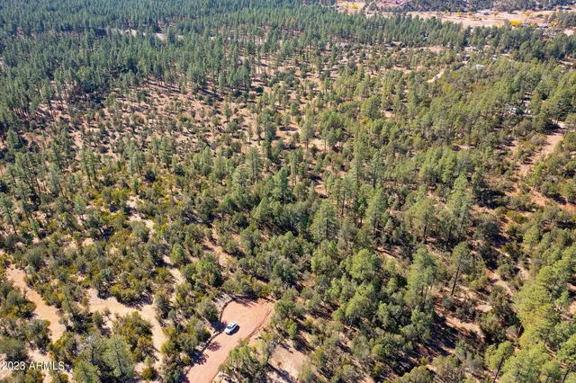 an aerial view of residential house and sandy dunes