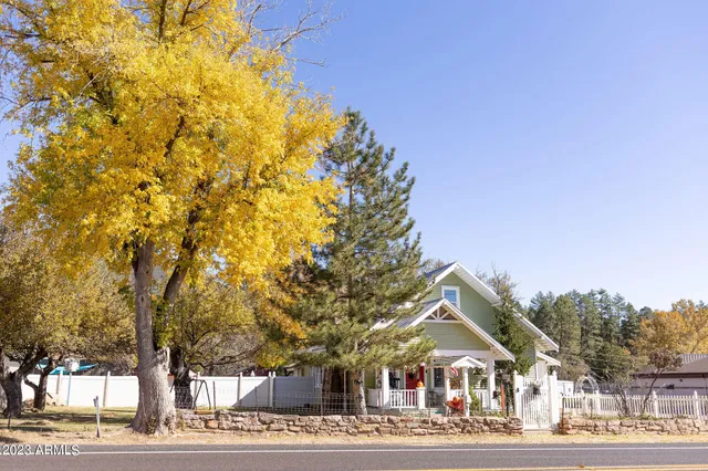 a view of a sign board with buildings in the background
