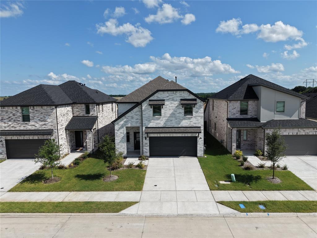 120 Millwood Road Lavon, TX 75166 - Photo 2 of 34 Modern two-story residence featuring light brick masonry with dark trim accents