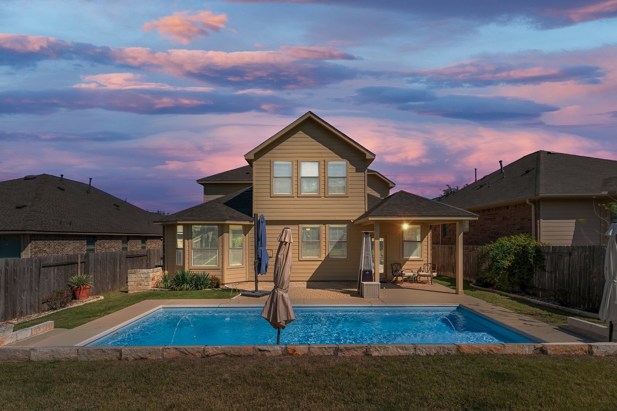 Back of house featuring a covered patio and a fenced backyard