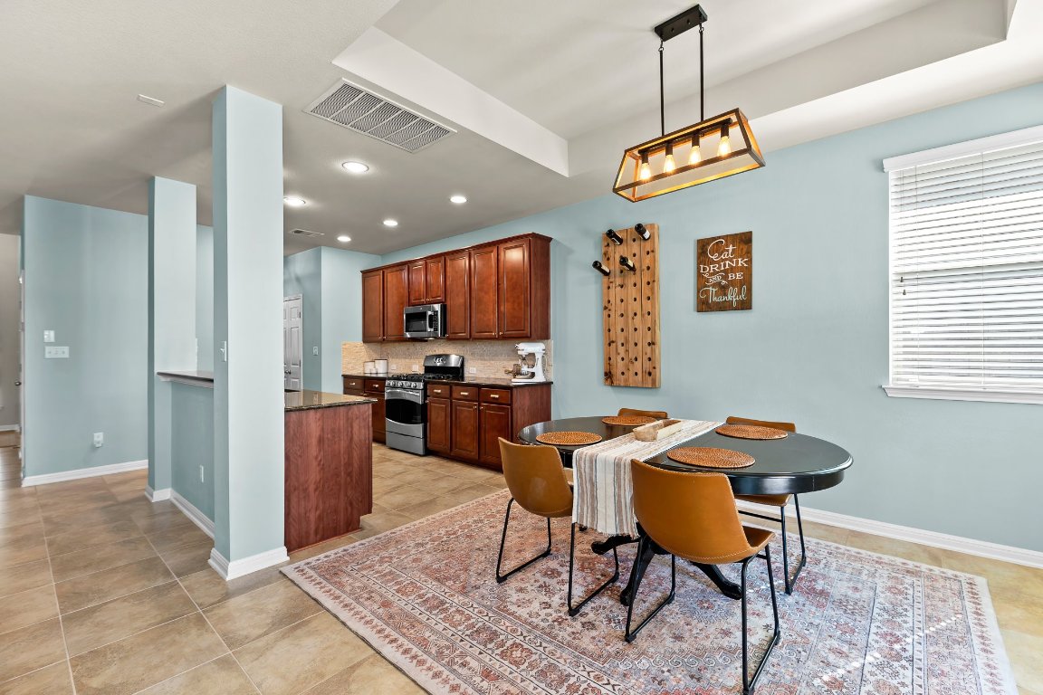 2813 Granite Hill Cove Leander, TX 78641 - Photo 11 of 35 a view of a dining room with furniture