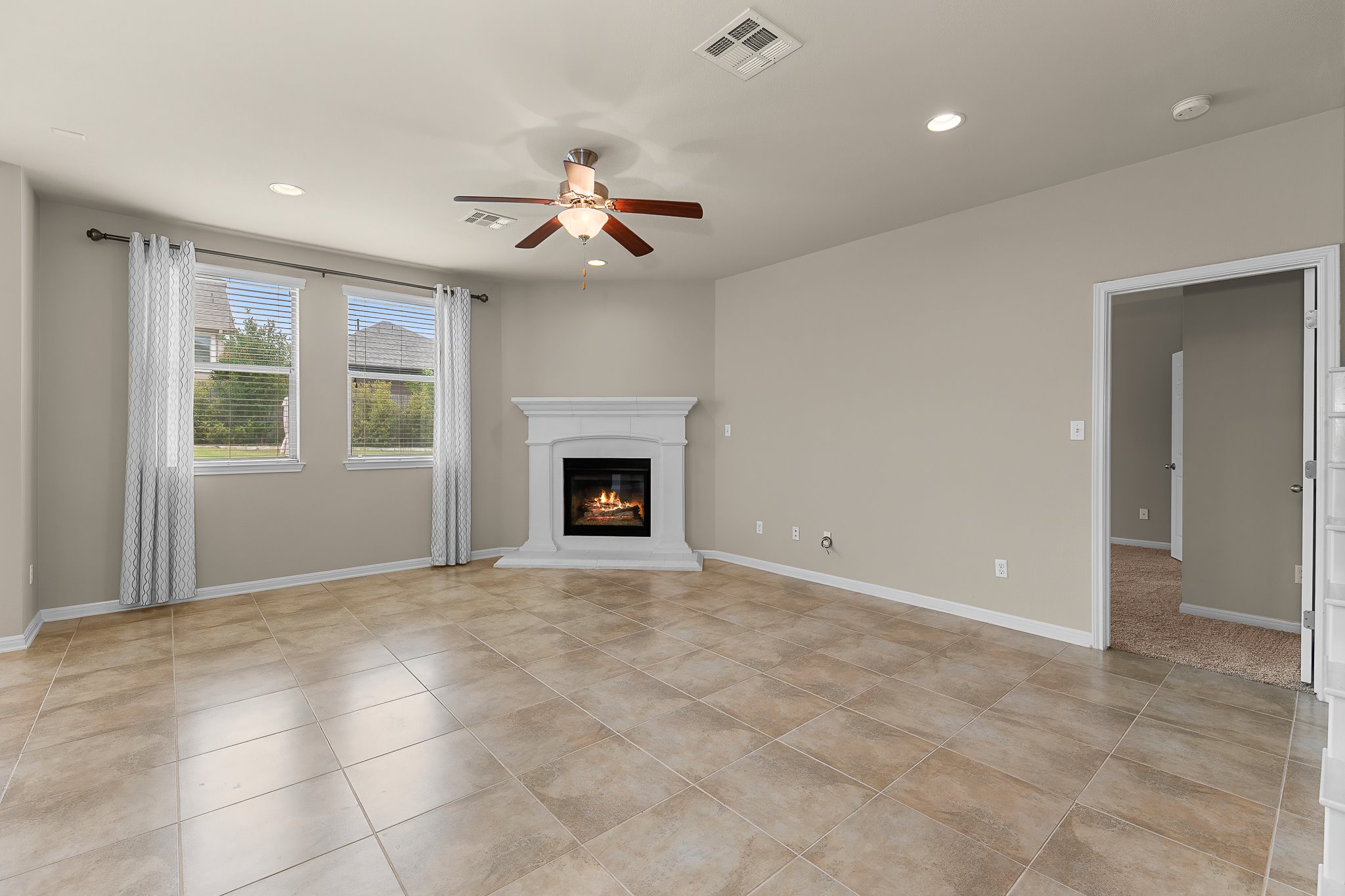 2813 Granite Hill Cove Leander, TX 78641 - Photo 11 of 39 Living room with a fireplace, ceiling fan, recessed lighting - freshly painted