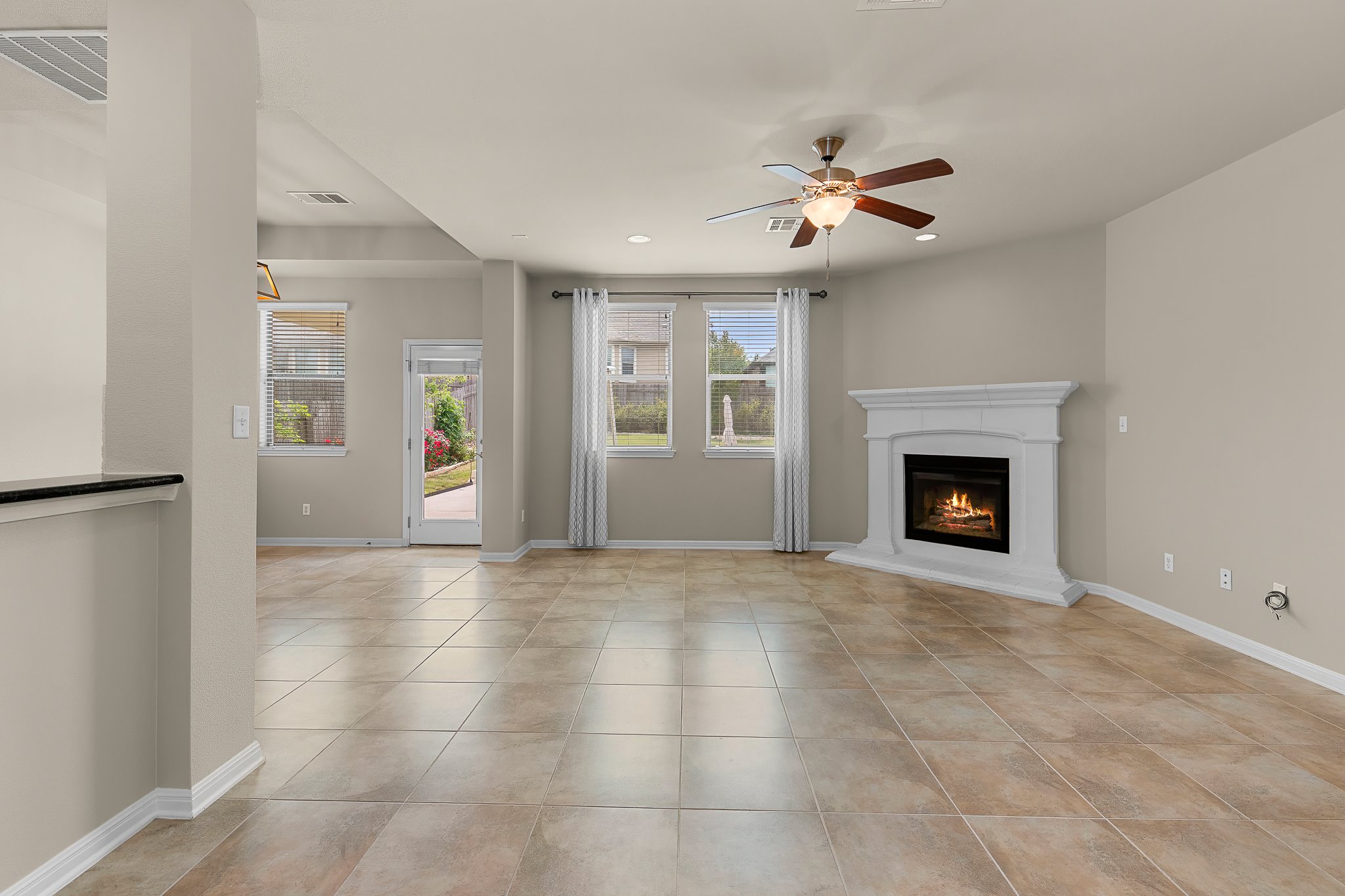 2813 Granite Hill Cove Leander, TX 78641 - Photo 12 of 39 Living room with a fireplace, ceiling fan, recessed lighting - freshly painted
