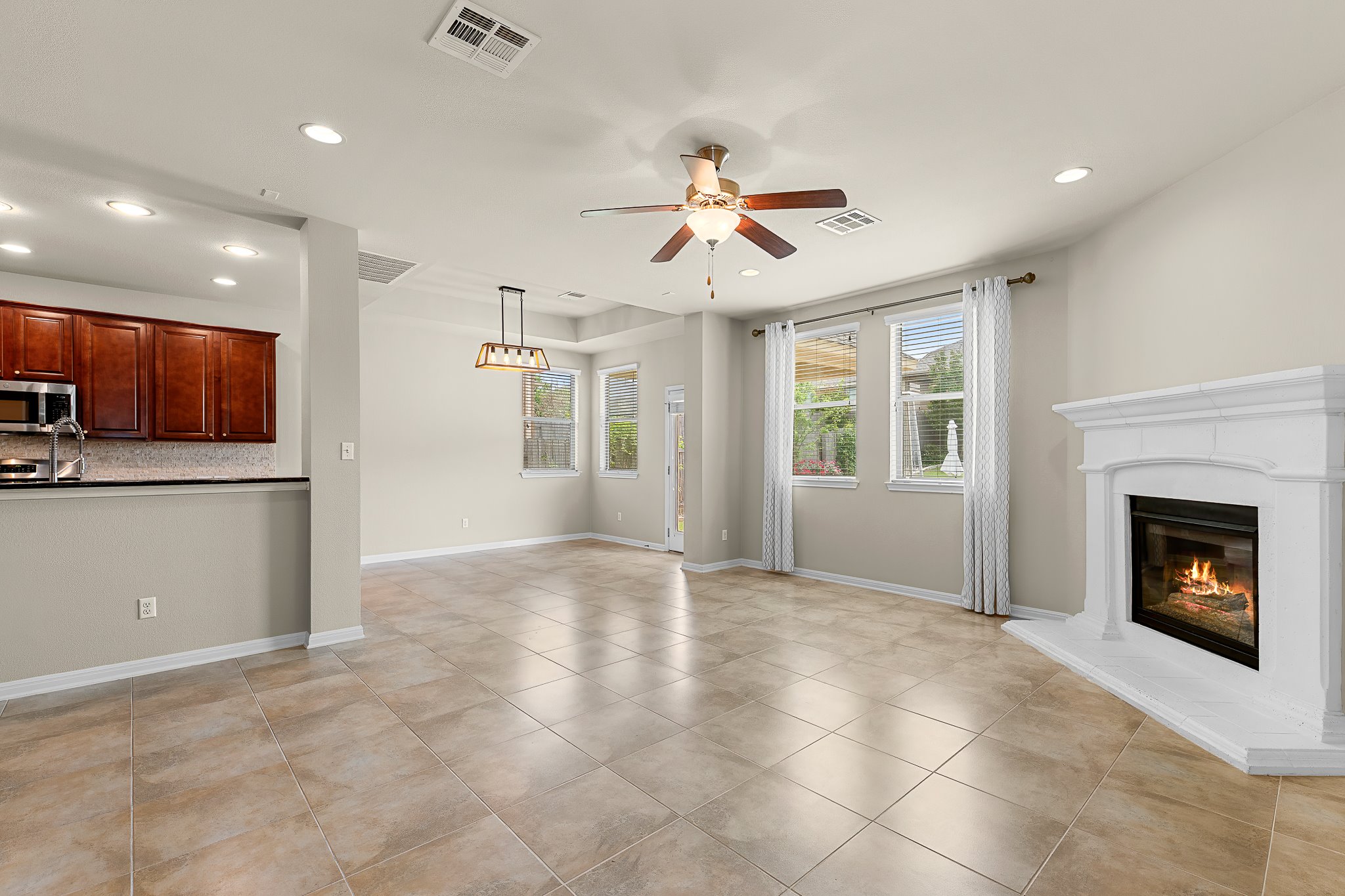2813 Granite Hill Cove Leander, TX 78641 - Photo 13 of 39 Living room with a fireplace, ceiling fan, recessed lighting - freshly painted