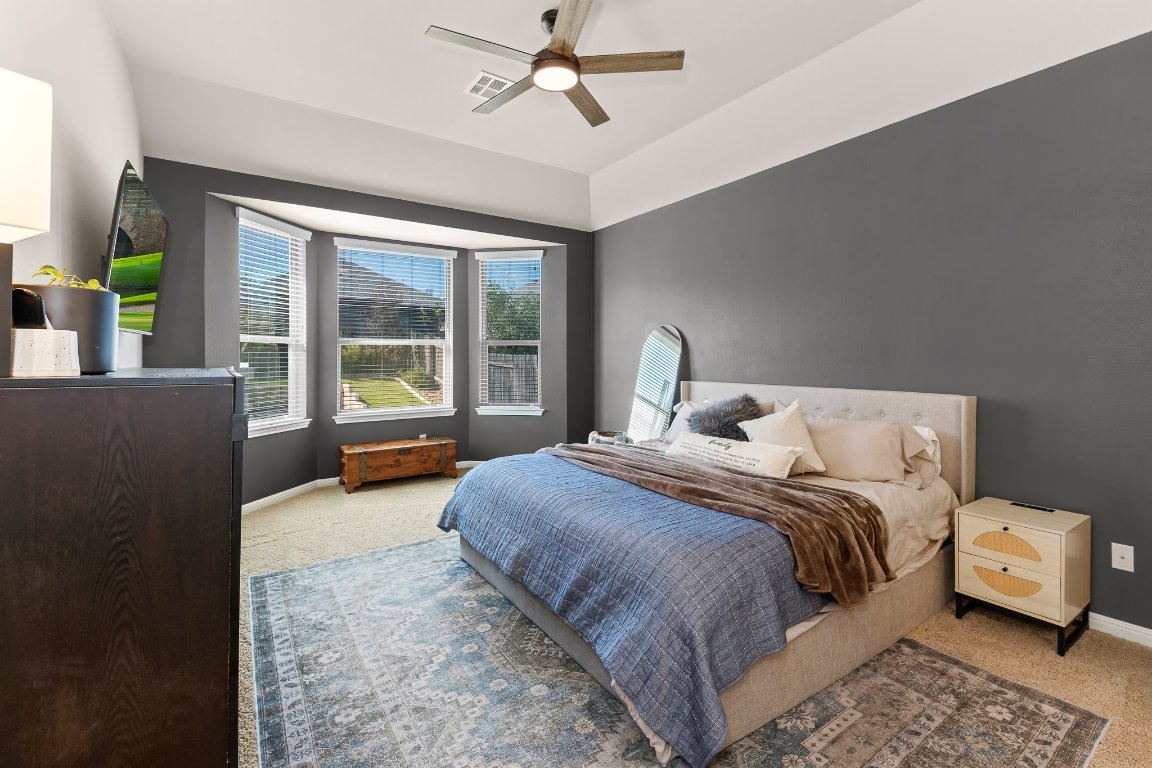 2813 Granite Hill Cove Leander, TX 78641 - Photo 20 of 35 a bedroom with a bed and a large window