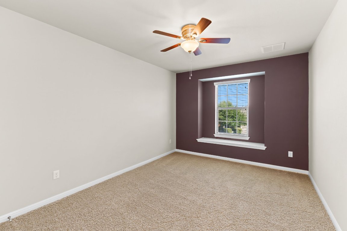 2813 Granite Hill Cove Leander, TX 78641 - Photo 27 of 35 an empty room with a window and a fan
