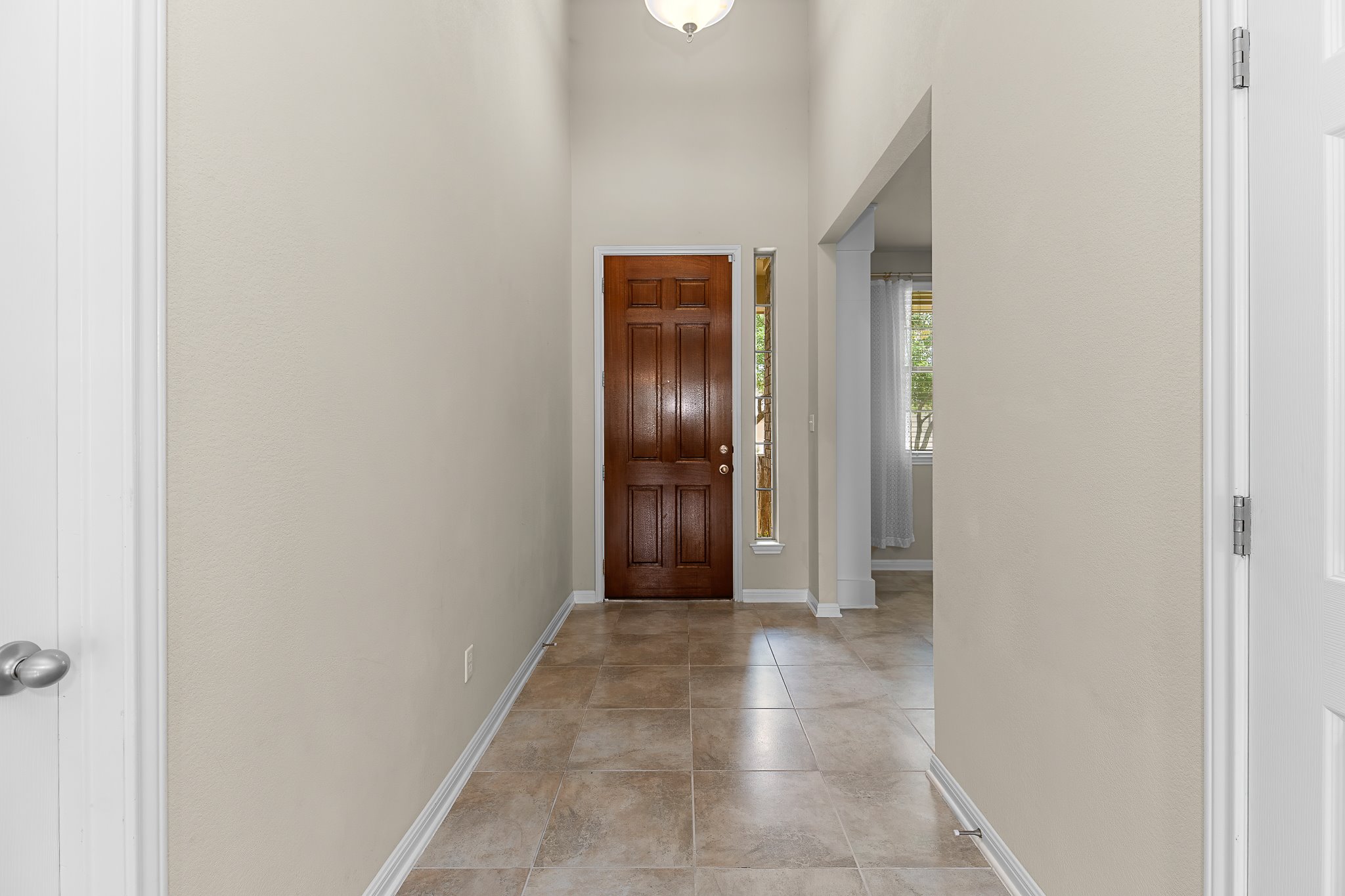 2813 Granite Hill Cove Leander, TX 78641 - Photo 34 of 39 Entryway featuring baseboards and a high ceiling
