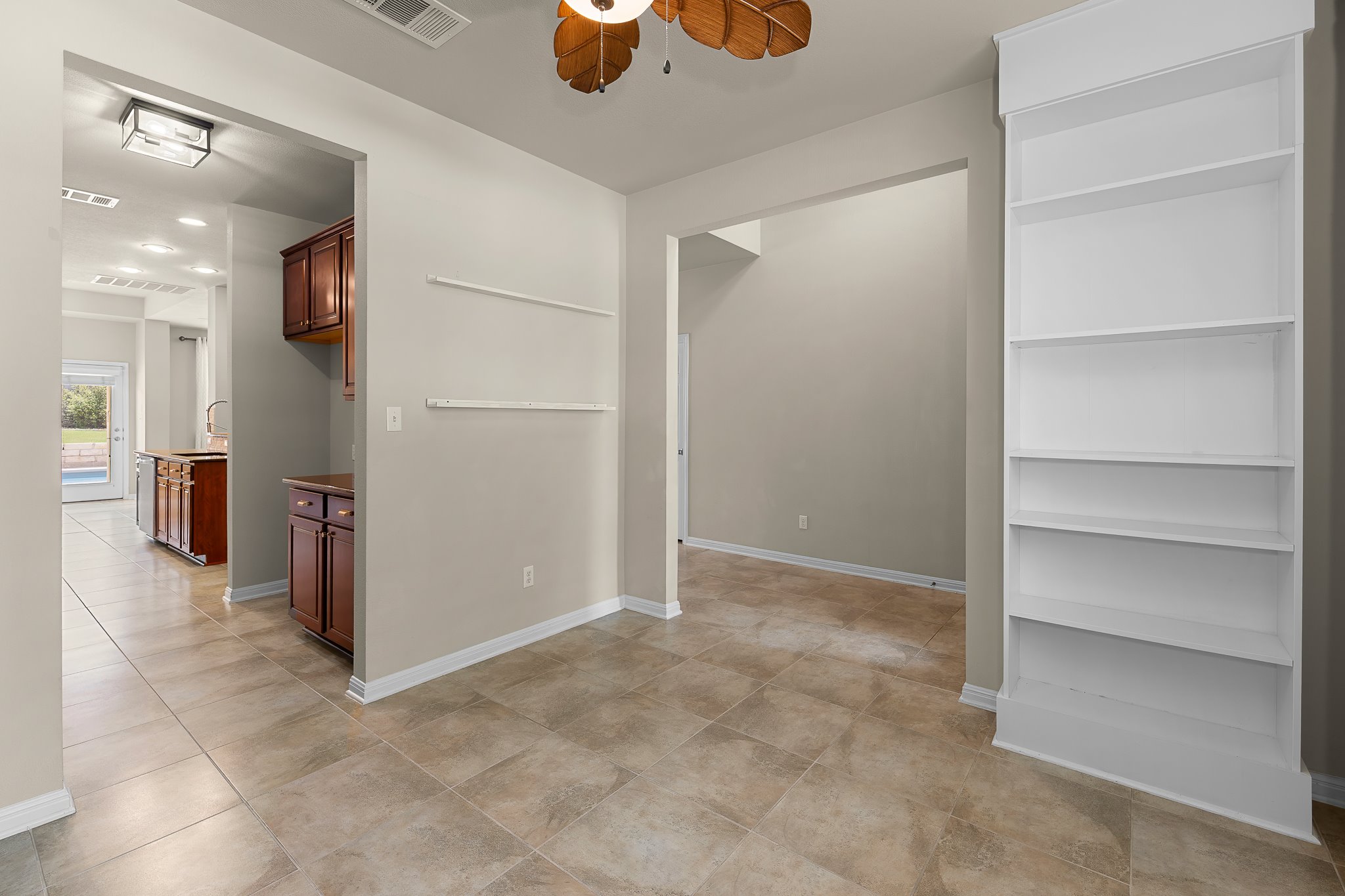 2813 Granite Hill Cove Leander, TX 78641 - Photo 8 of 39 Home office featuring wallpapered walls, an accent wall and a ceiling fan - freshly painted