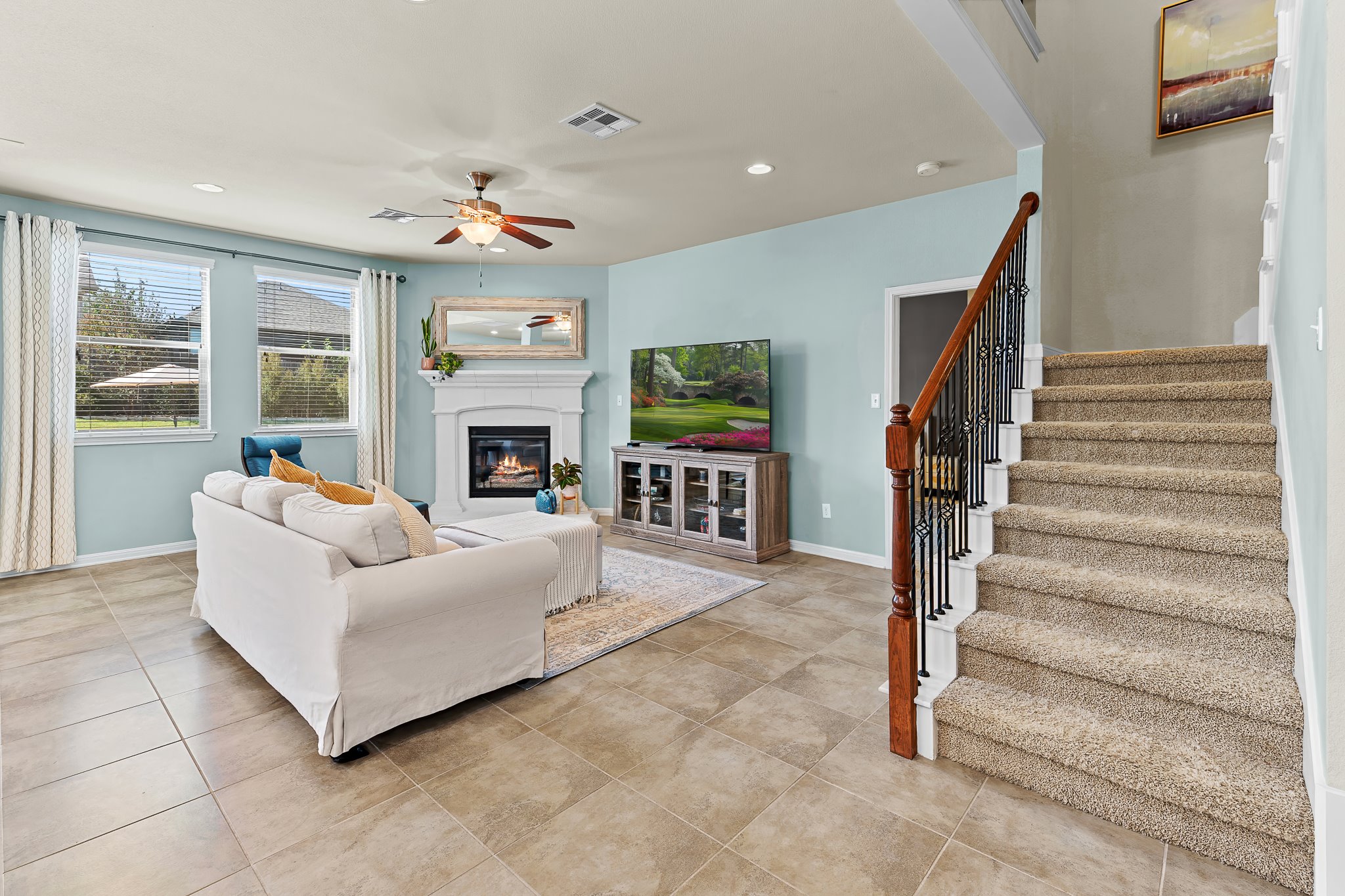 2813 Granite Hill Cove Leander, TX 78641 - Photo 8 of 35 Living area featuring ceiling fan, recessed lighting, a fireplace, stairway, and light tile patterned flooring