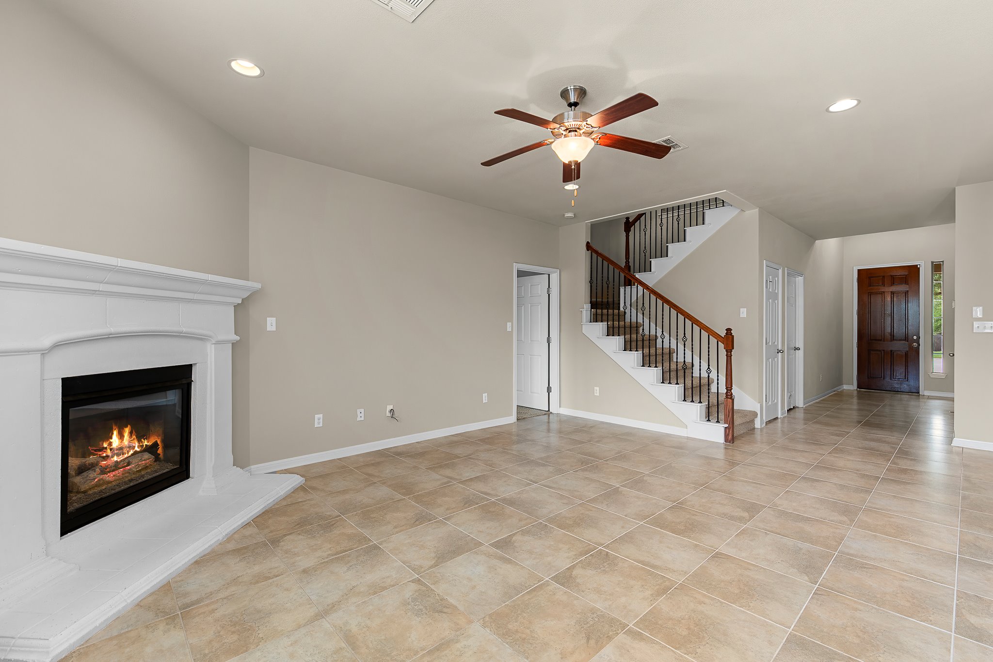 2813 Granite Hill Cove Leander, TX 78641 - Photo 10 of 39 Living room with a fireplace, ceiling fan, recessed lighting - freshly painted