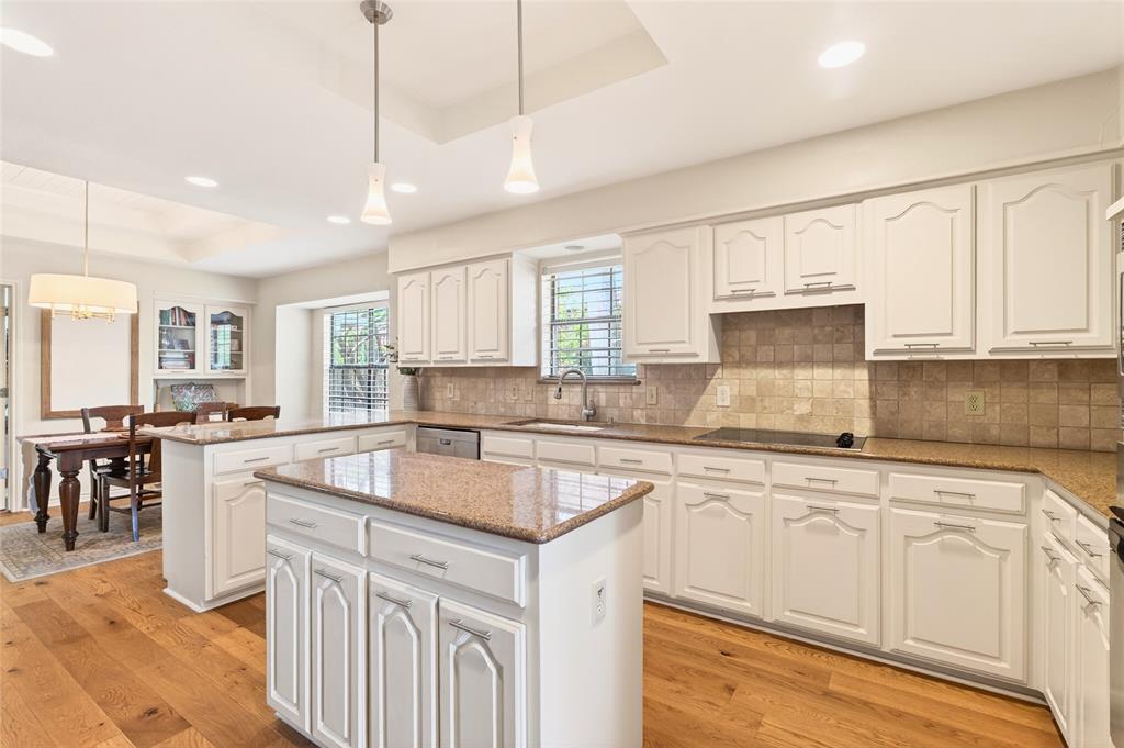 819 Lockhaven Lane Coppell, TX 75019 - Photo 14 of 33 The island anchors the space, finished with two pendant lights that add just enough contrast overhead.