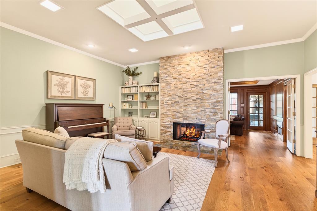 819 Lockhaven Lane Coppell, TX 75019 - Photo 5 of 33 A double-sided fireplace connects this space to the adjoining living area, keeping everything tied together.