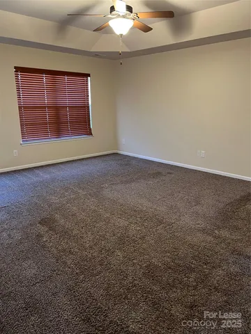 an empty room with a empty space & windows