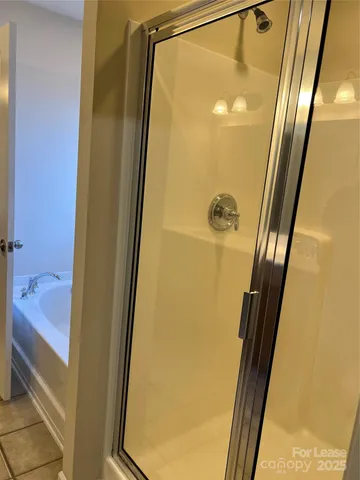 a bathroom with a tub and a glass door