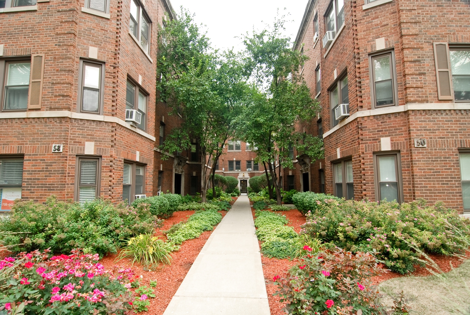a view of a brick building next to a yard