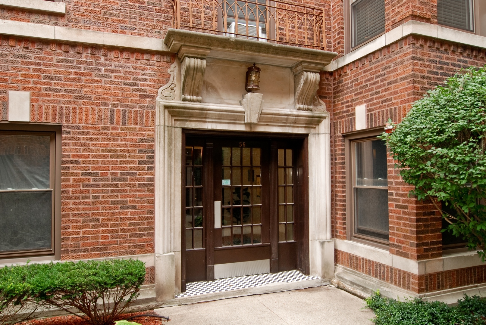 56 Forest Avenue, Unit 1N Riverside, IL 60546 - Photo 2 of 21 a front view of a house with a garden
