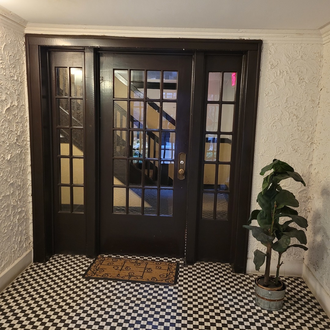 56 Forest Avenue, Unit 1N Riverside, IL 60546 - Photo 3 of 21 a bedroom with a bed and a table