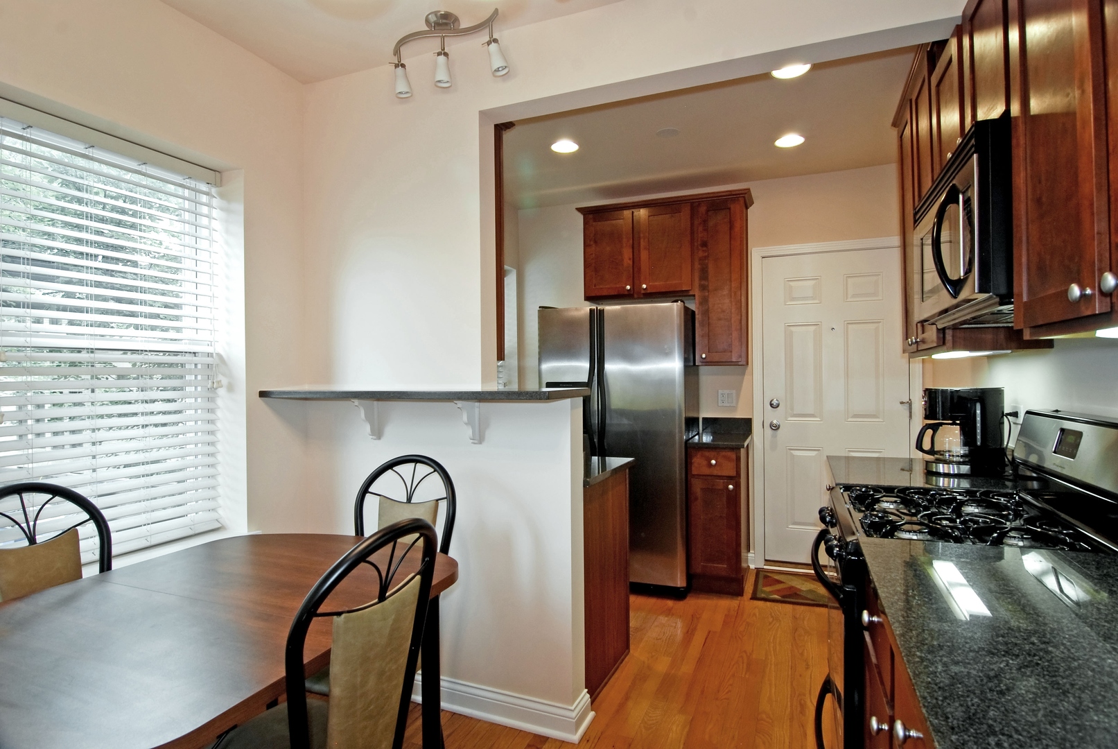 56 Forest Avenue, Unit 1N Riverside, IL 60546 - Photo 9 of 21 a kitchen with a refrigerator a sink a stove and furniture
