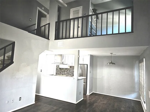 a kitchen with a refrigerator and a stove