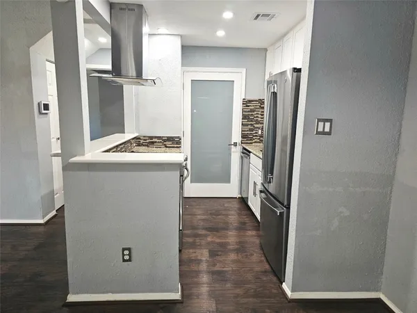 a view of entryway and hall with a dining table