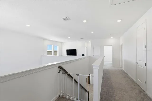 a view of a hallway with stairs