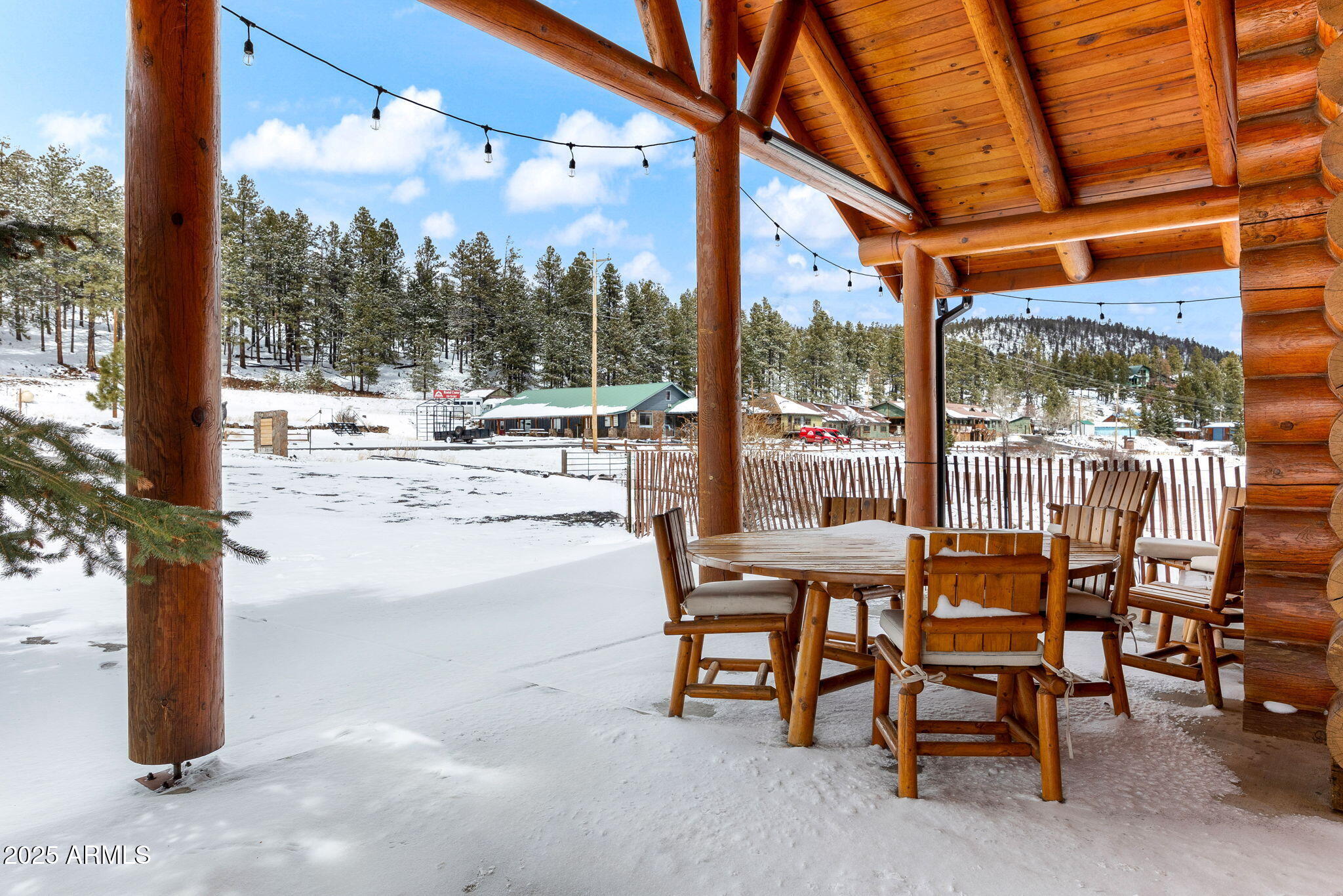 100 Main Street Greer, AZ 85927 - Photo 58 of 63 a view of a patio with a table chairs and a floor to ceiling window