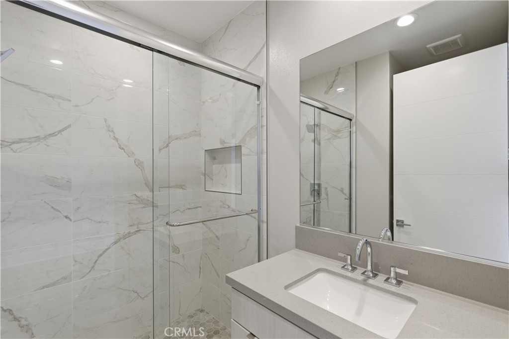 156 Apron Irvine, CA 92618 - Photo 23 of 40 a bathroom with a sink shower and a mirror