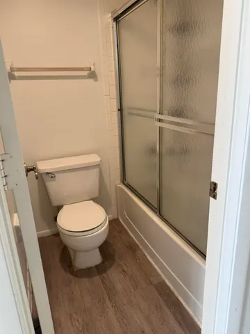a bathroom with a toilet and a shower