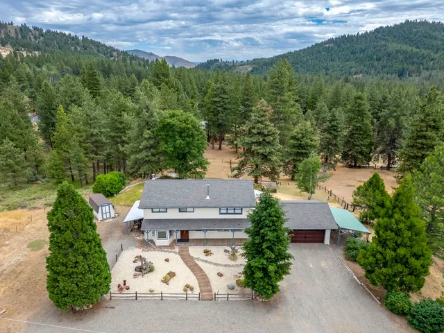 an aerial view of a house with lots of trees