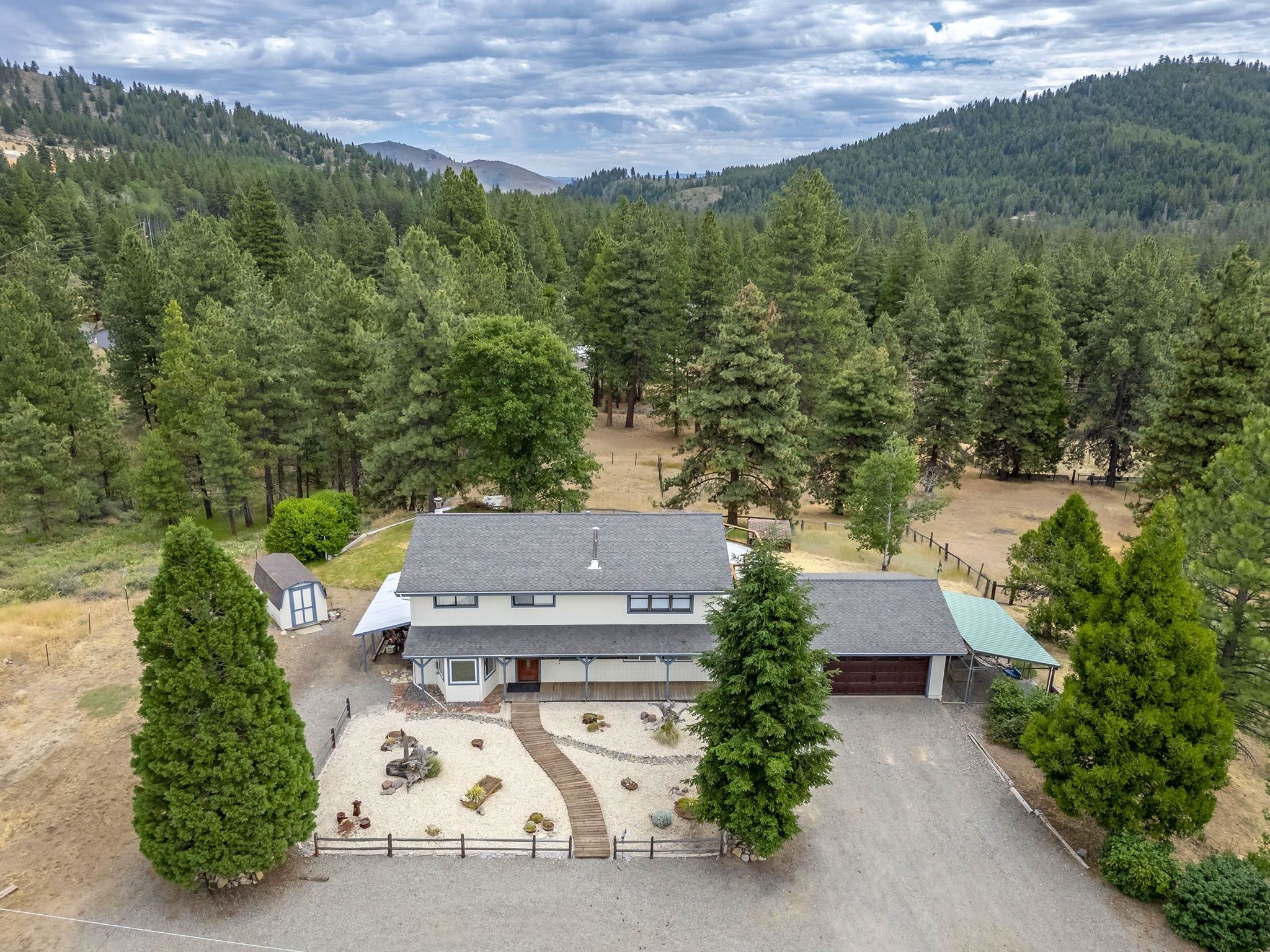 an aerial view of a house with lots of trees