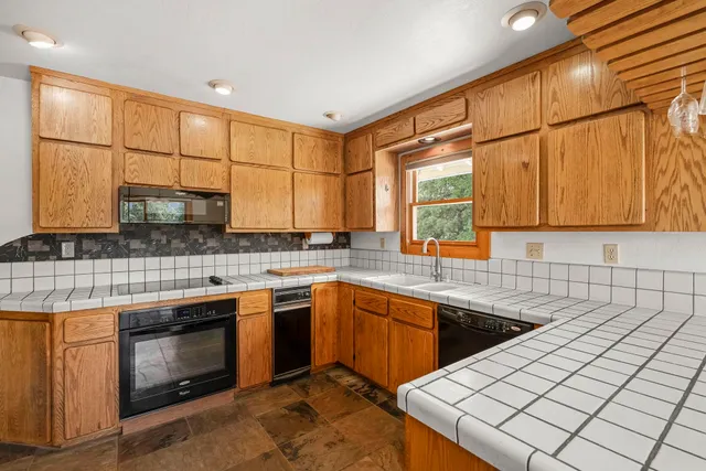 a kitchen that has a sink and a stove in it